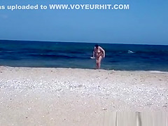 Pregnant nudist woman at beach
