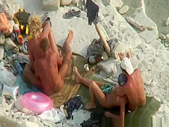 Two nudist couples in beach