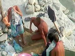 Two nudist couples in beach