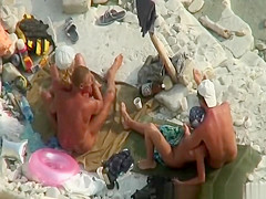 Two nudist couples in beach