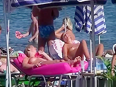 Topless women sunbathing