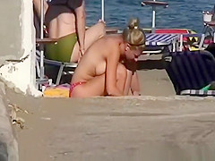 Topless women sunbathing