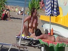 Topless women sunbathing