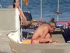 Topless women sunbathing