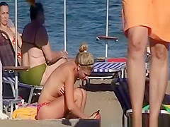 Topless women sunbathing