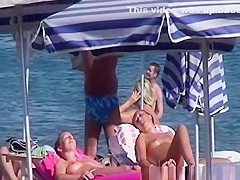 Topless women sunbathing
