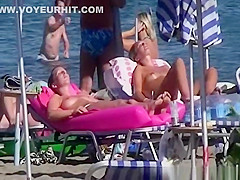 Topless women sunbathing