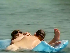 Couple plays around on an air mattress