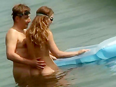 Couple plays around on an air mattress