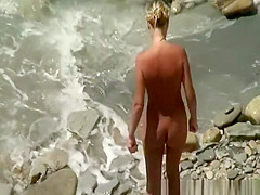 Small boobs nudist refreshing in the water