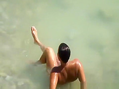 Chubby nudist sunbathing in beach