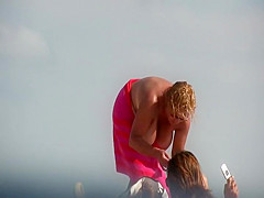 Gigantic mature tits on a beach
