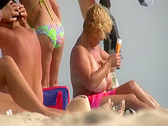 Gigantic mature tits on a beach