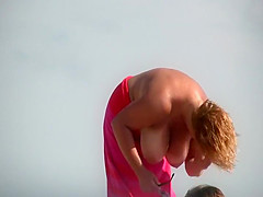 Gigantic mature tits on a beach