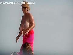 Gigantic mature tits on a beach