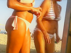 Hot beach babe waits for her friend