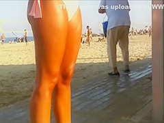 Hot beach babe waits for her friend