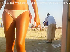 Hot beach babe waits for her friend