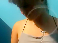 Woman undresses in a dressing cabin