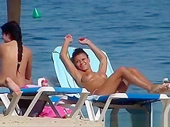 Pretty topless girls sunbathing on the beach