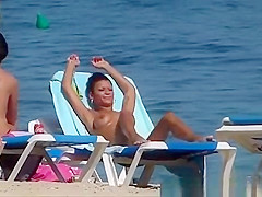 Pretty topless girls sunbathing on the beach