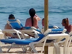 Pretty topless girls sunbathing on the beach