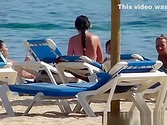 Pretty topless girls sunbathing on the beach