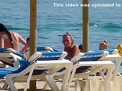 Pretty topless girls sunbathing on the beach