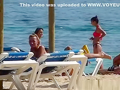 Pretty topless girls sunbathing on the beach