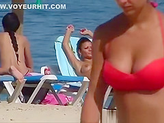 Pretty topless girls sunbathing on the beach