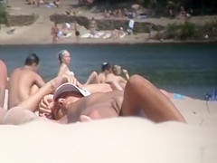 Brunette nudist woman sunbathing