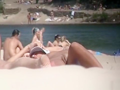 Brunette nudist woman sunbathing