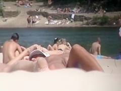 Brunette nudist woman sunbathing