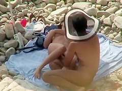 Guy with a funny hat fingers his girl