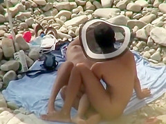 Guy with a funny hat fingers his girl