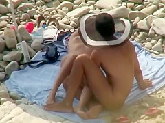 Guy with a funny hat fingers his girl