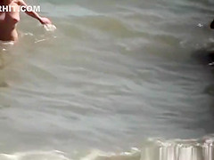 Nudist blonde woman caught in nudist beach