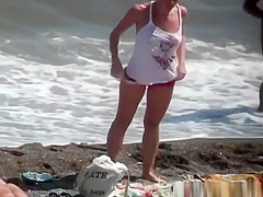 Nudist blonde woman caught in nudist beach