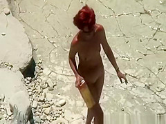 Redhead nudist sunbating her body