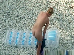 Woman arrives to the beach and undresses