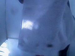 Woman in beach cabin changing from bikini