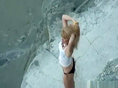 Nudist woman takes off her black bikini