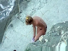 Nudist woman takes off her black bikini