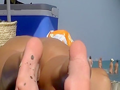 Nudist women spied in the beach sunbathing