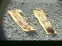 Small boobs nude woman at the rocky beach