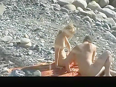 Small boobs nude woman at the rocky beach