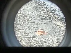 Small boobs nude woman at the rocky beach