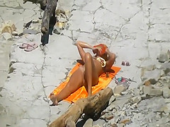 Spying a pretty girl as she sun tans