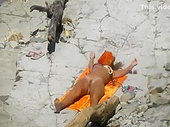 Spying a pretty girl as she sun tans
