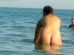 Sexy nudist girl enters the water